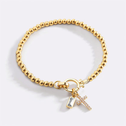 Pulsera con charm de cruz y piedra de nacimiento