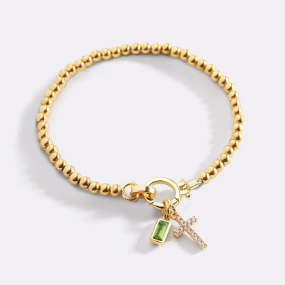 Pulsera con charm de cruz y piedra de nacimiento