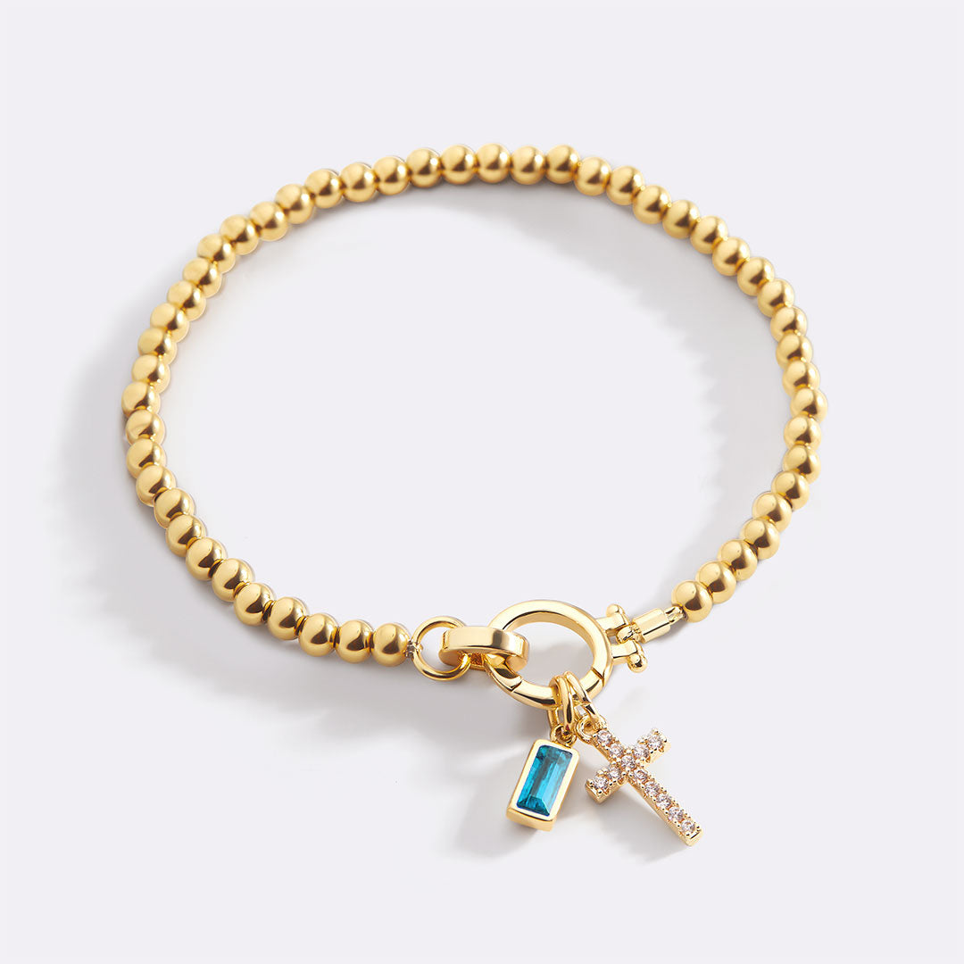 Pulsera con charm de cruz y piedra de nacimiento