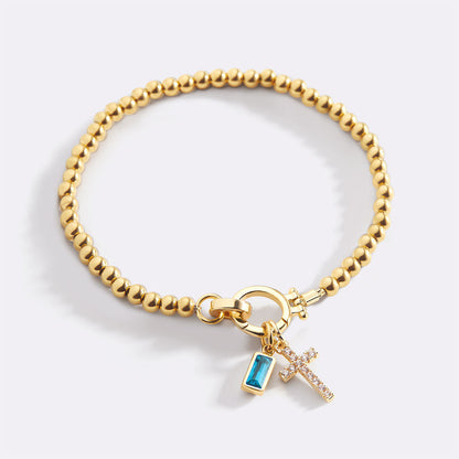 Pulsera con charm de cruz y piedra de nacimiento