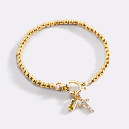 Pulsera con charm de cruz y piedra de nacimiento