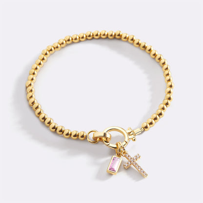 Pulsera con charm de cruz y piedra de nacimiento