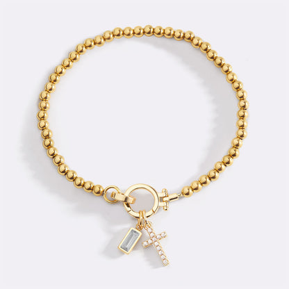Pulsera con charm de cruz y piedra de nacimiento