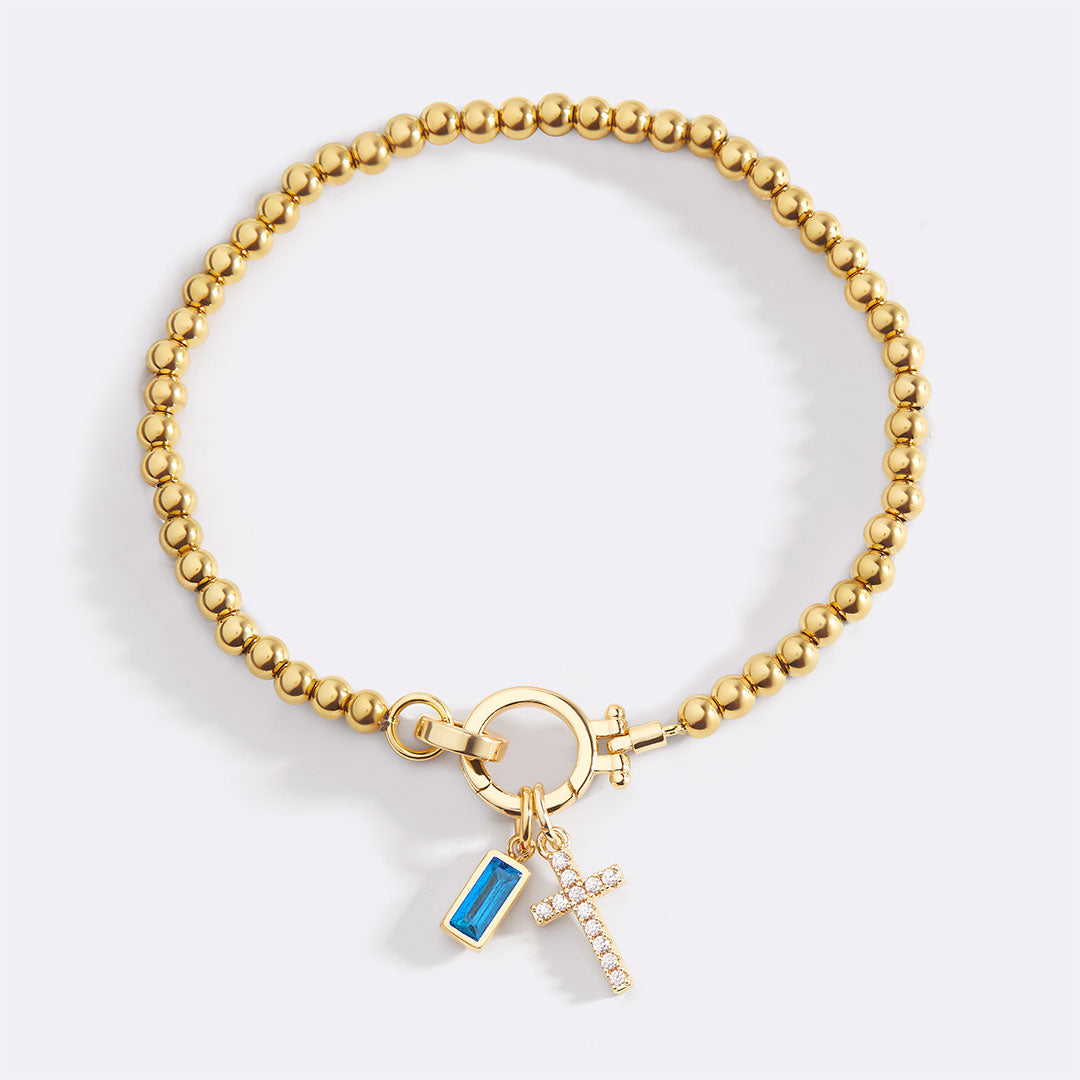 Pulsera con charm de cruz y piedra de nacimiento