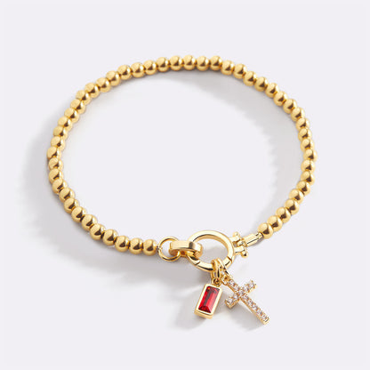 Pulsera con charm de cruz y piedra de nacimiento
