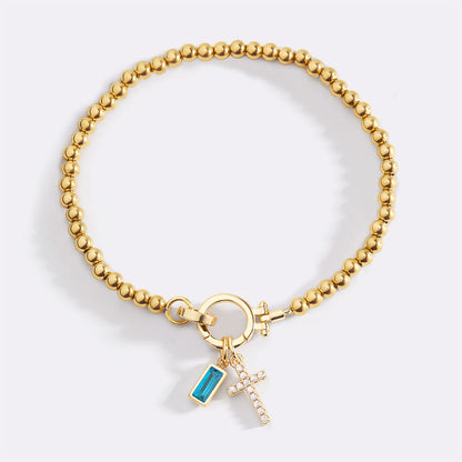 Pulsera con charm de cruz y piedra de nacimiento