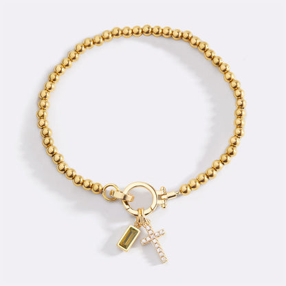 Pulsera con charm de cruz y piedra de nacimiento