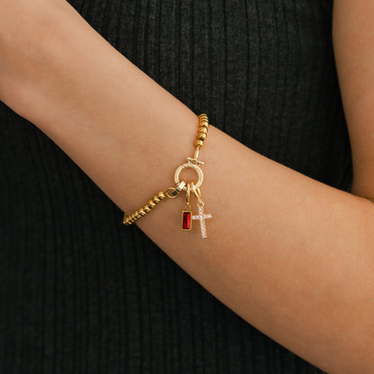 Pulsera con charm de cruz y piedra de nacimiento