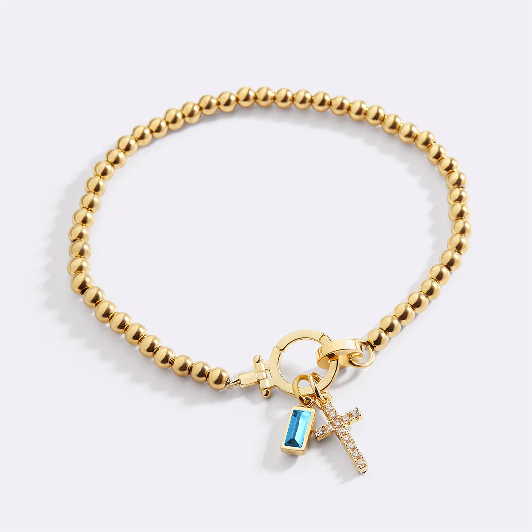 Pulsera con charm de cruz y piedra de nacimiento