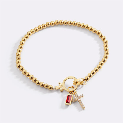Pulsera con charm de cruz y piedra de nacimiento