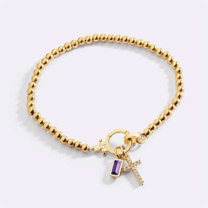 Pulsera con charm de cruz y piedra de nacimiento